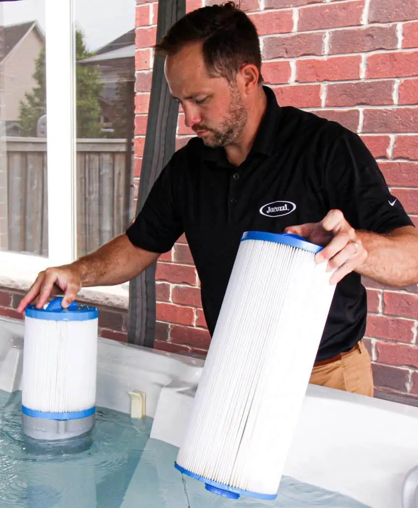 man changing hot tub filter